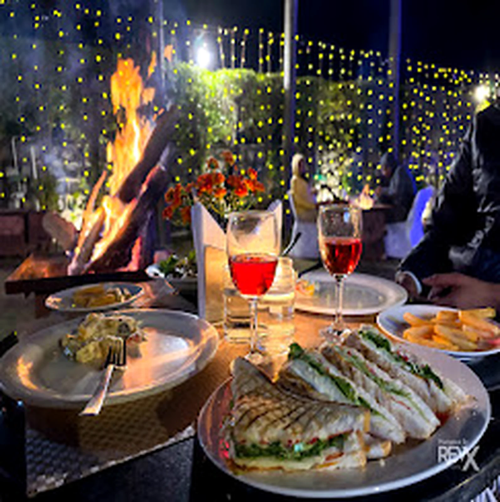 Dinner setting with a fire feature and plated food