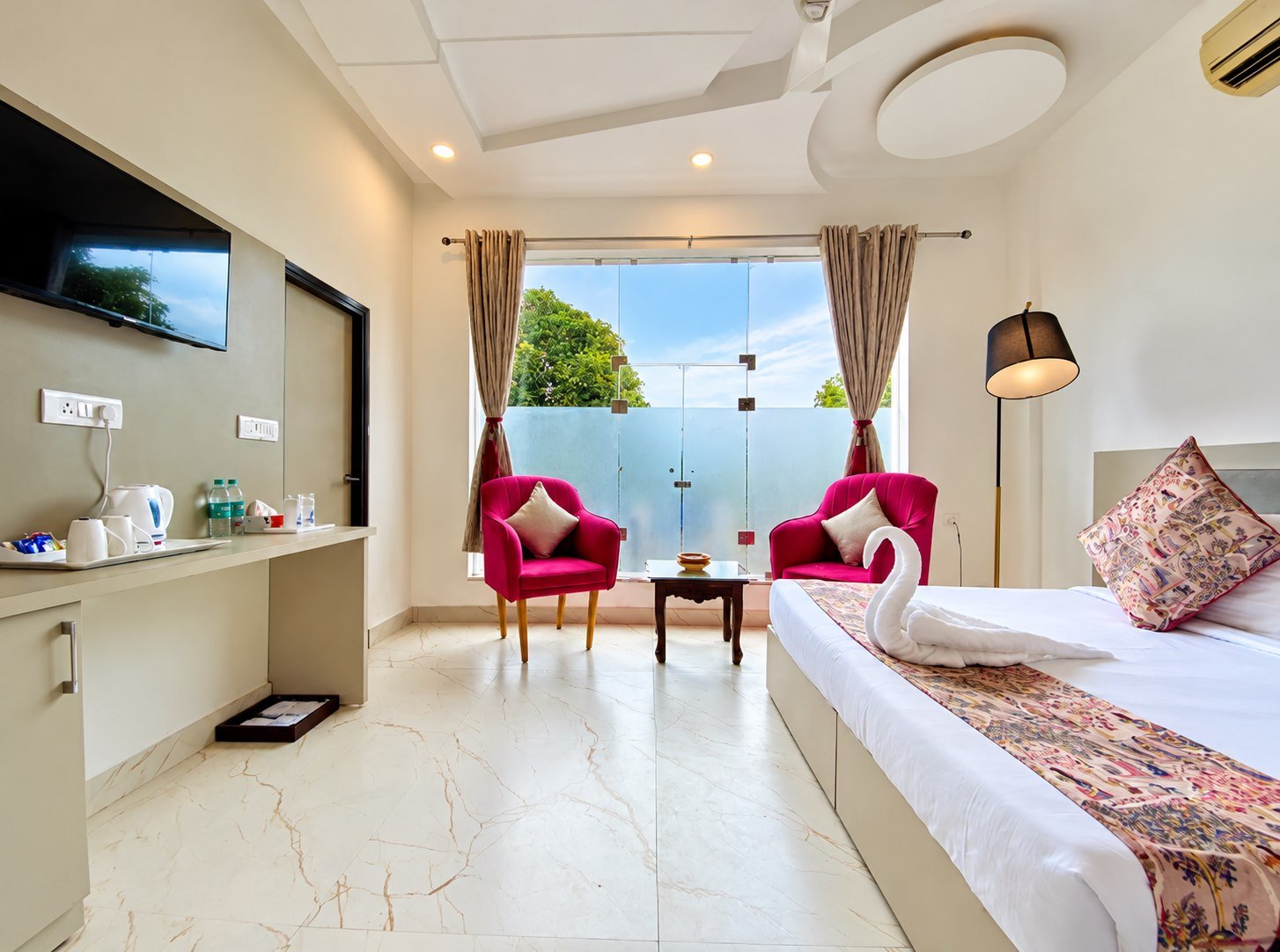 Suite with a king-size bed, bright sitting area and balcony window